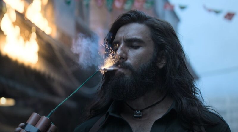 Man with long hair and beard smoking a traditional hookah at sunset.