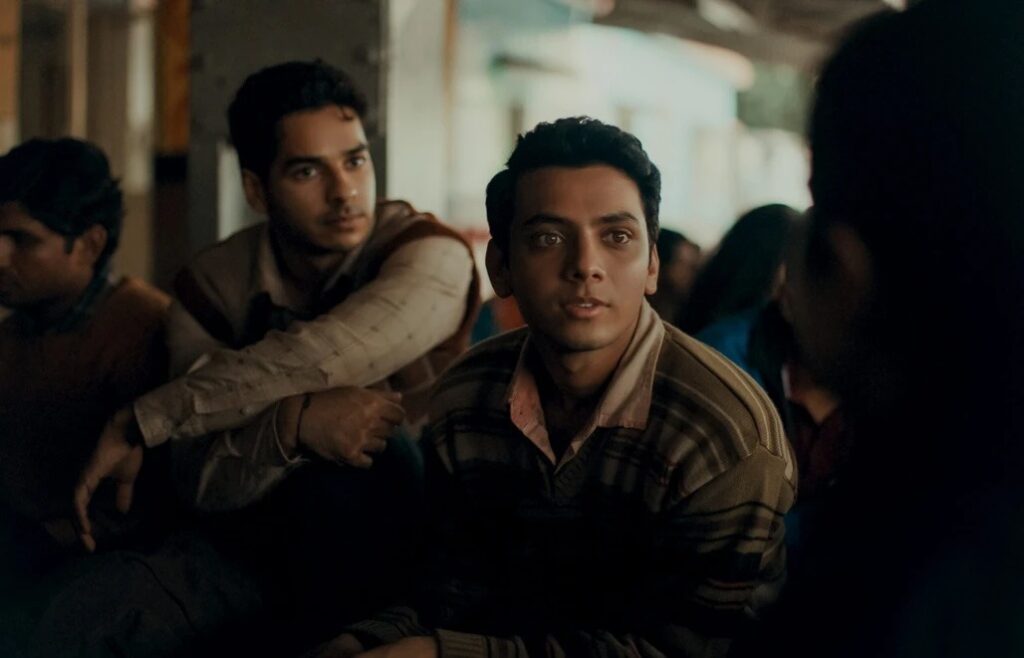 Young man engaged in a serious conversation in a social setting, focused and attentive.