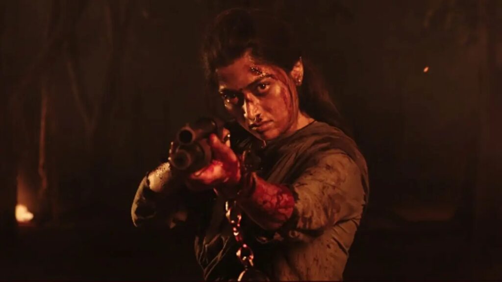 A woman aiming a gun in a tense, dramatic scene from the movie "Soochna Tantra.".