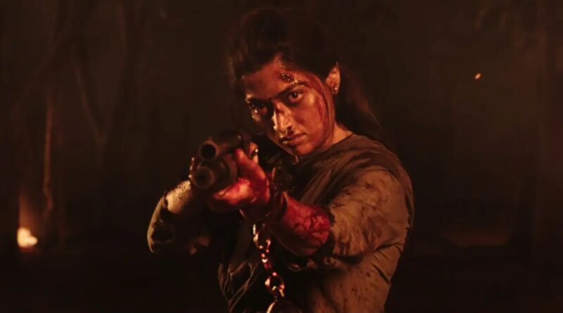 A woman aiming a gun in a tense, dramatic scene from the movie "Soochna Tantra.".