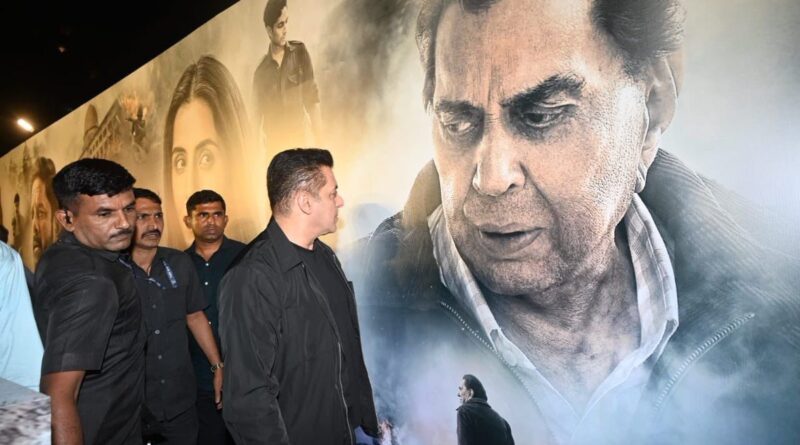 A detailed mural featuring a prominent man's portrait with visitors observing the artwork.