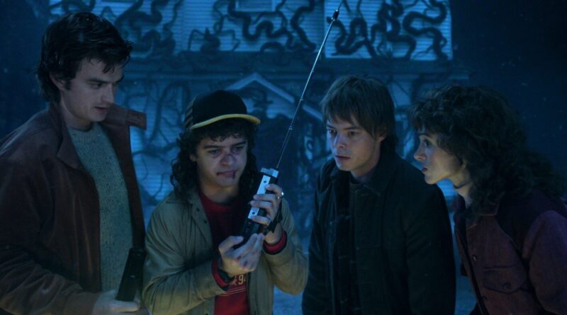 A mysterious group of teenagers investigates a walkie-talkie in a dark, eerie setting.