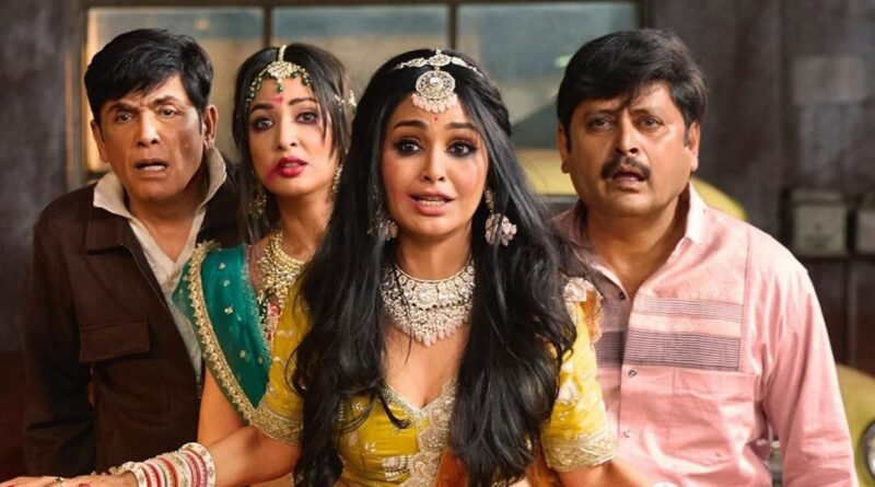 A woman dressed in traditional Indian attire with surprised expressions, surrounded by three men als.