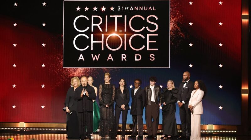 Elegant group of award winners on stage at the Critics' Choice Awards 2023 event.