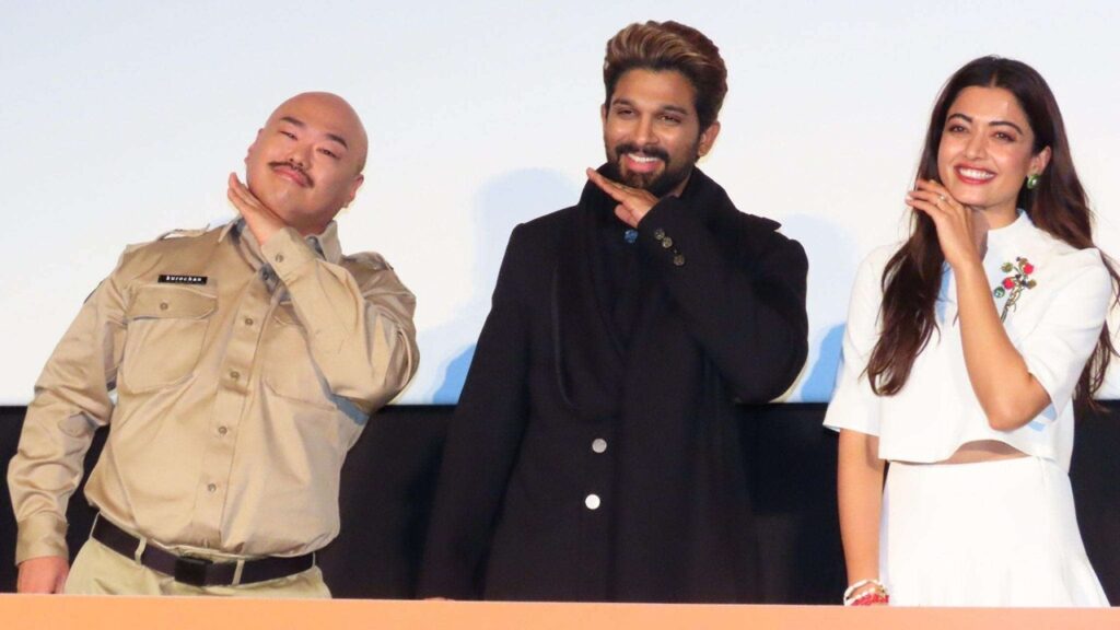 Diverse group of three people smiling and posing confidently at an event.