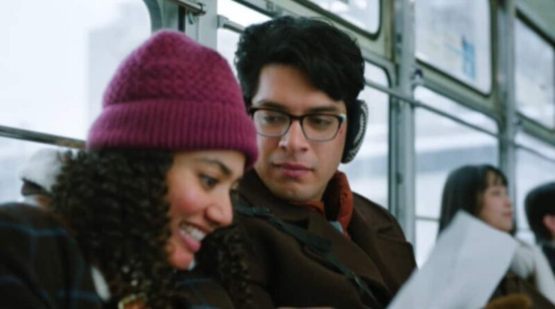 A woman and man wearing headphones on a bus, engaging with their devices.